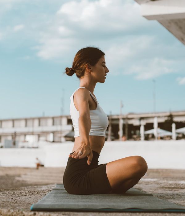 Woman in a calm yoga pose, embodying harmony and balance.